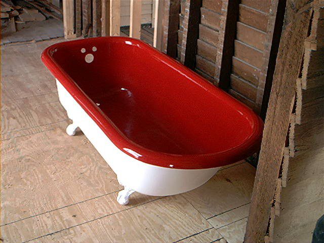 a porcelain bath tub with a red interior