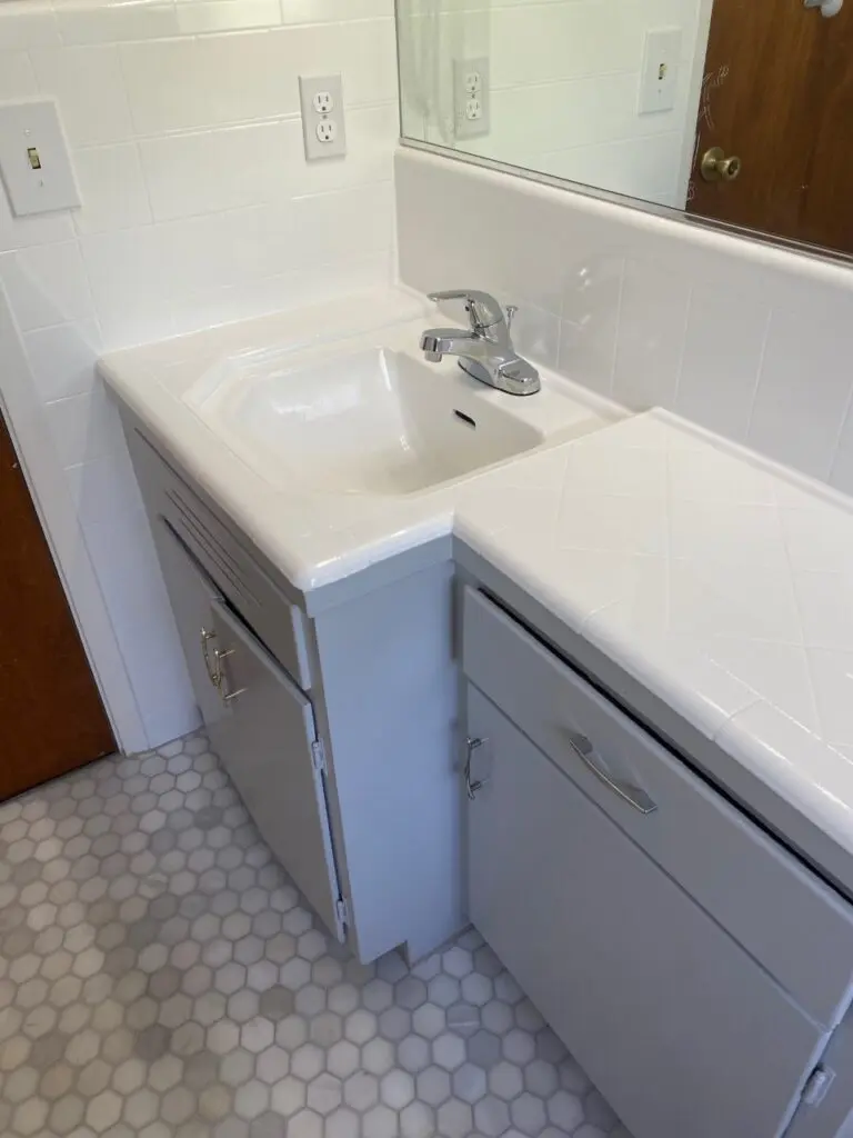 a porcelain sink in a white bathroom