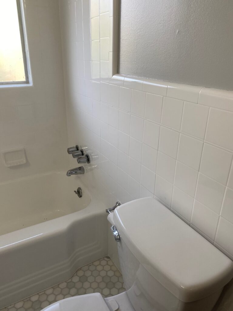 a bathroom wall with clean white tiles